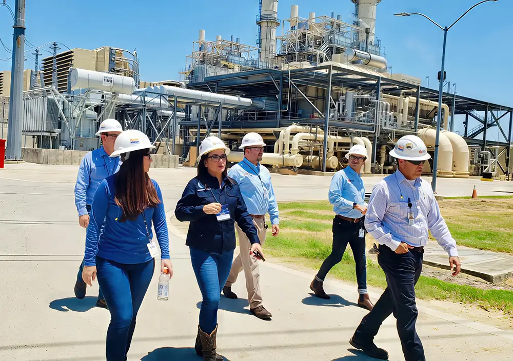 Lori Cobos leading an on-site walkthrough at an energy facility