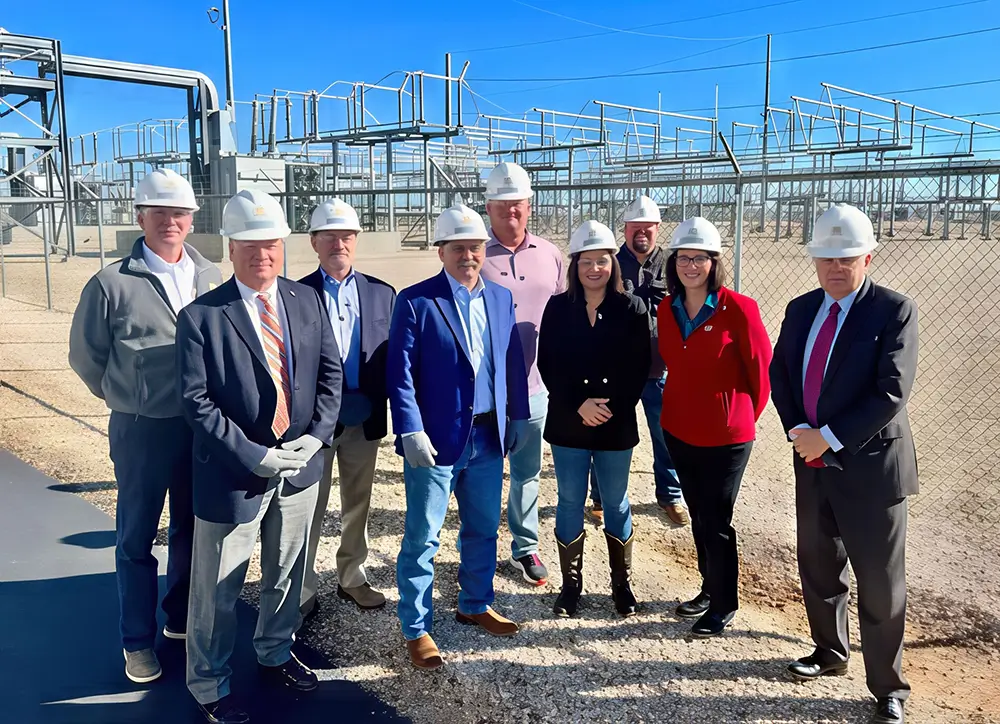 Lori Cobos leading an on-site walkthrough at an energy facility